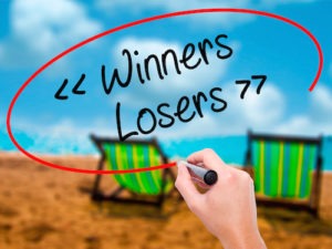 Man Hand writing Winners - Losers