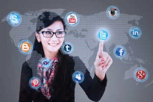 Close-up of businesswoman touching social media application