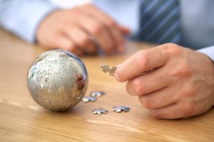 Businessman solving globe puzzle concept for business solutions and strategy