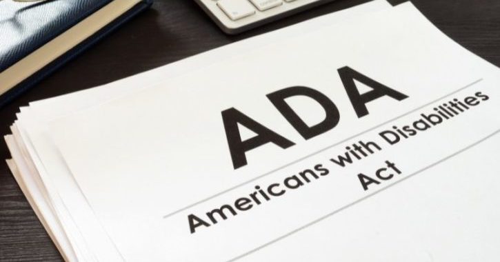a paper entitled "ADA, Americans with disabilities act" sits on a desk