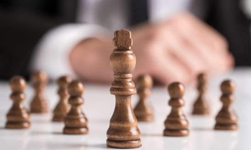 business person playing chess