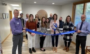 business people at ribbon cutting ceremony